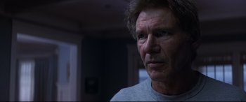 Movie still from “What Lies Beneath” (2000), directed by Robert Zemeckis – A person wearing a gray t - shirt; Close Up shot, Over the shoulder angle