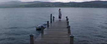 Movie still from “What Lies Beneath” (2000), directed by Robert Zemeckis – A woman standing on a pier looking out over the water; Wide shot, High angle