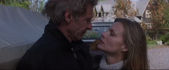Movie still from “What Lies Beneath” (2000), directed by Robert Zemeckis – A man and a woman kissing each other in the street; Close Up shot, Low angle
