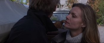 Movie still from “What Lies Beneath” (2000), directed by Robert Zemeckis – A man and a woman in the back seat of a car; Close Up shot, Over the shoulder angle