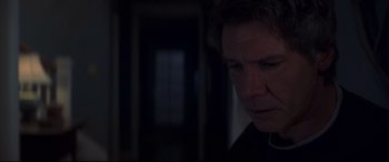 Movie still from “What Lies Beneath” (2000), directed by Robert Zemeckis – A man in a dark room looking down at the floor; Close Up shot, Over the shoulder angle
