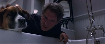 Movie still from “What Lies Beneath” (2000), directed by Robert Zemeckis – A man leaning on a wall in a bathroom; Close Up shot, Low angle