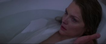 Movie still from “What Lies Beneath” (2000), directed by Robert Zemeckis – A beautiful woman sitting in a bath tub at night; Close Up shot, Overhead angle