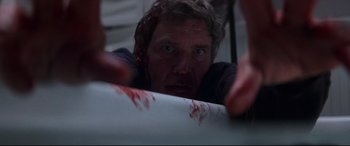 Movie still from “What Lies Beneath” (2000), directed by Robert Zemeckis – A man with blood on his face looking at the camera; Close Up shot, Low angle