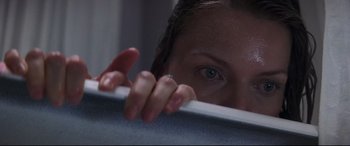 Movie still from “What Lies Beneath” (2000), directed by Robert Zemeckis – A woman hiding her face behind a white wall; Extreme Close Up shot, Overhead angle