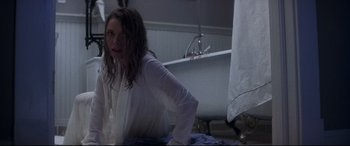 Movie still from “What Lies Beneath” (2000), directed by Robert Zemeckis – A woman sitting on a bed next to a bath tub; Medium shot, Over the shoulder angle