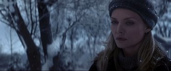 Movie still from “What Lies Beneath” (2000), directed by Robert Zemeckis – A person wearing a hat in the snow; Close Up shot, Over the shoulder angle