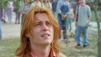Movie still from “What's Eating Gilbert Grape” (1993), directed by Lasse Hallström – A man with long hair is looking up at the sky; Close Up shot, Low angle