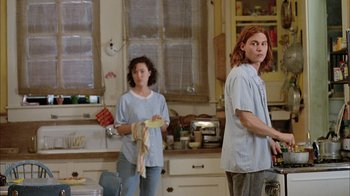 Movie still from “What's Eating Gilbert Grape” (1993), directed by Lasse Hallström – A man and a woman standing in a kitchen; Medium shot, Low angle