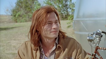 Movie still from “What's Eating Gilbert Grape” (1993), directed by Lasse Hallström – A person with long red hair; Close Up shot, Over the shoulder angle