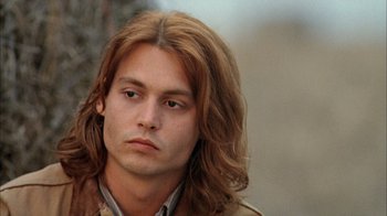Movie still from “What's Eating Gilbert Grape” (1993), directed by Lasse Hallström – A person with long brown hair; Close Up shot, Low angle