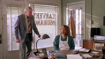 Movie still from “What's Eating Gilbert Grape” (1993), directed by Lasse Hallström – A man and a woman sitting at a table; Medium shot, Low angle