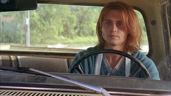 Movie still from “What's Eating Gilbert Grape” (1993), directed by Lasse Hallström – A man sitting in the driver's seat of a car; Close Up shot, Low angle