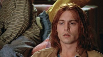 Movie still from “What's Eating Gilbert Grape” (1993), directed by Lasse Hallström – A person with long red hair; Close Up shot, Low angle