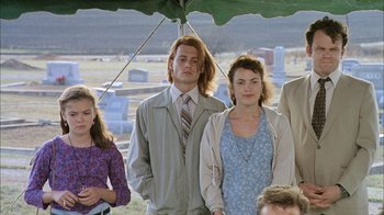 Movie still from “What's Eating Gilbert Grape” (1993), directed by Lasse Hallström – A group of people standing next to each other under an awning; Medium shot, High angle