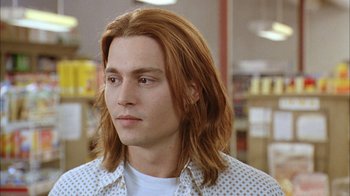 Movie still from “What's Eating Gilbert Grape” (1993), directed by Lasse Hallström – A person with long red hair; Close Up shot, Low angle