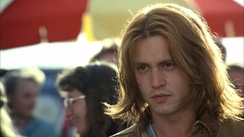 Movie still from “What's Eating Gilbert Grape” (1993), directed by Lasse Hallström – A person with long brown hair; Close Up shot, Low angle
