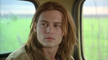 Movie still from “What's Eating Gilbert Grape” (1993), directed by Lasse Hallström – A person with long brown hair; Close Up shot, Over the shoulder angle