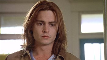 Movie still from “What's Eating Gilbert Grape” (1993), directed by Lasse Hallström – A person with long brown hair; Close Up shot, Low angle