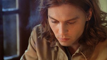 Movie still from “What's Eating Gilbert Grape” (1993), directed by Lasse Hallström – A person with long brown hair; Close Up shot, High angle