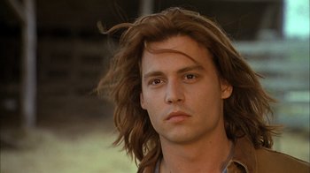 Movie still from “What's Eating Gilbert Grape” (1993), directed by Lasse Hallström – A person with long brown hair; Close Up shot, Low angle