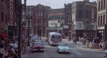 Movie still from “What's Love Got to Do with It” (1993), directed by Brian Gibson – A city street filled with lots of traffic; Wide shot, High angle
