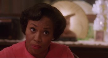 Movie still from “What's Love Got to Do with It” (1993), directed by Brian Gibson – A woman with a surprised look on her face; Close Up shot, Over the shoulder angle