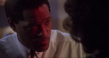 Movie still from “What's Love Got to Do with It” (1993), directed by Brian Gibson – A person wearing a white dress shirt; Close Up shot, Over the shoulder angle