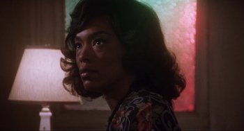 Movie still from “What's Love Got to Do with It” (1993), directed by Brian Gibson – A person with long hair is looking into the distance; Close Up shot, Low angle
