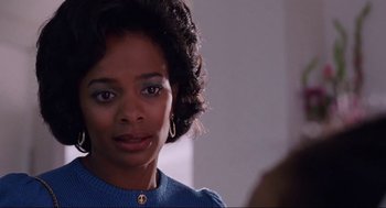 Movie still from “What's Love Got to Do with It” (1993), directed by Brian Gibson – A person wearing a blue shirt; Close Up shot, Over the shoulder angle
