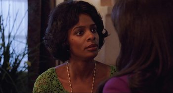 Movie still from “What's Love Got to Do with It” (1993), directed by Brian Gibson – A woman that is talking to another woman; Close Up shot, Over the shoulder angle