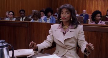 Movie still from “What's Love Got to Do with It” (1993), directed by Brian Gibson – An african american woman in a court room; Medium shot, Low angle