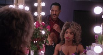 Movie still from “What's Love Got to Do with It” (1993), directed by Brian Gibson – A man and a woman in front of a vanity mirror; Medium shot, Over the shoulder angle