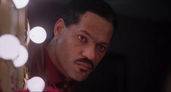 Movie still from “What's Love Got to Do with It” (1993), directed by Brian Gibson – A person wearing a red shirt; Close Up shot, Low angle