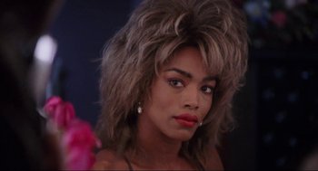 Movie still from “What's Love Got to Do with It” (1993), directed by Brian Gibson – A person wearing a wig; Close Up shot, Low angle