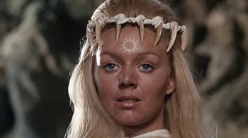 Movie still from “When Dinosaurs Ruled the Earth” (1970), directed by Val Guest – A person wearing a crown; Close Up shot, Low angle