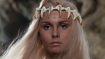 Movie still from “When Dinosaurs Ruled the Earth” (1970), directed by Val Guest – A person wearing a headband; Close Up shot, High angle