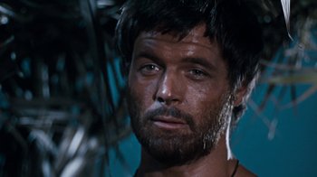 Movie still from “When Dinosaurs Ruled the Earth” (1970), directed by Val Guest – A person with a beard; Close Up shot, Low angle