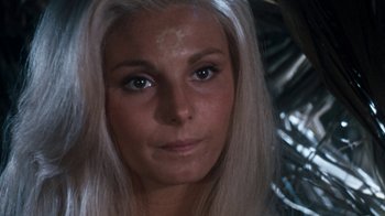 Movie still from “When Dinosaurs Ruled the Earth” (1970), directed by Val Guest – A woman with long white hair and a sun symbol painted on her forehead; Close Up shot, Low angle