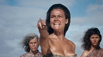 Movie still from “When Dinosaurs Ruled the Earth” (1970), directed by Val Guest – An old woman and a young woman pointing to the sky; Medium shot, Low angle