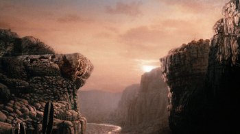 Movie still from “When Dinosaurs Ruled the Earth” (1970), directed by Val Guest – A view of a valley with a mountain range in the background; Extreme Wide shot, High angle
