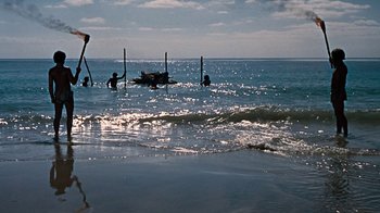 Movie still from “When Dinosaurs Ruled the Earth” (1970), directed by Val Guest – A group of people in the water near the shore; Extreme Wide shot, High angle