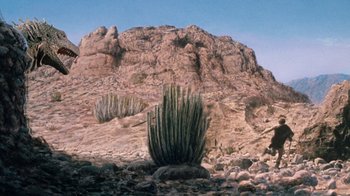 Movie still from “When Dinosaurs Ruled the Earth” (1970), directed by Val Guest – A cactus in front of a rocky hill; Extreme Wide shot, Low angle