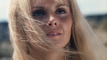 Movie still from “When Dinosaurs Ruled the Earth” (1970), directed by Val Guest – A woman's face with long blonde hair blowing in the wind; Close Up shot, Low angle