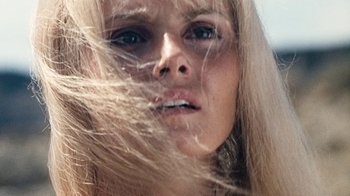 Movie still from “When Dinosaurs Ruled the Earth” (1970), directed by Val Guest – A woman's face with long blonde hair blowing in the wind; Extreme Close Up shot, Low angle