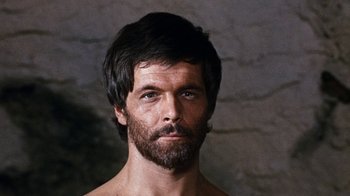 Movie still from “When Dinosaurs Ruled the Earth” (1970), directed by Val Guest – A person with a beard; Close Up shot, Low angle