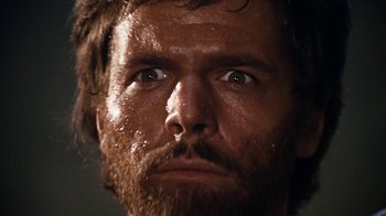 Movie still from “When Dinosaurs Ruled the Earth” (1970), directed by Val Guest – A man's face with water droplets on his face; Close Up shot, Low angle