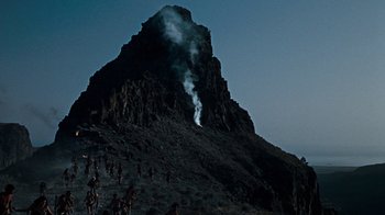 Movie still from “When Dinosaurs Ruled the Earth” (1970), directed by Val Guest – A group of people standing on top of a mountain; Extreme Wide shot, High angle