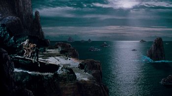 Movie still from “When Dinosaurs Ruled the Earth” (1970), directed by Val Guest – A body of water that has some rocks on it; Extreme Wide shot, High angle