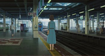 Movie still from “When Marnie Was There” (2014), directed by Hiromasa Yonebayashi – A woman standing in front of a train platform; Wide shot, High angle